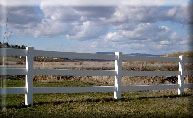 3 rail white vinyl with Mt Spokane in the background installed by valley fence