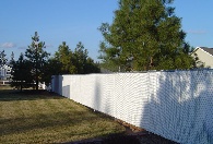 White PDS slats with 2 3/8 line posts to support the slats and fence during those windy days